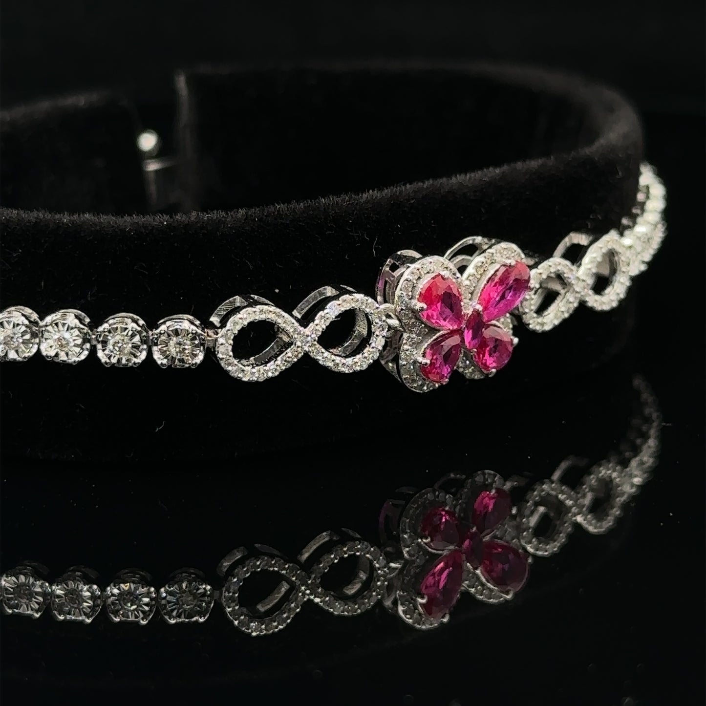 White gold and Diamond Butterfly & Infinity bracelet with Multicolored Red Stones.